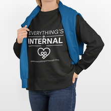 Load image into Gallery viewer, Person wearing a black unisex sweatshirt with “Everything’s Internal” logo and a blue jacket draped over their shoulders, standing against a white background.